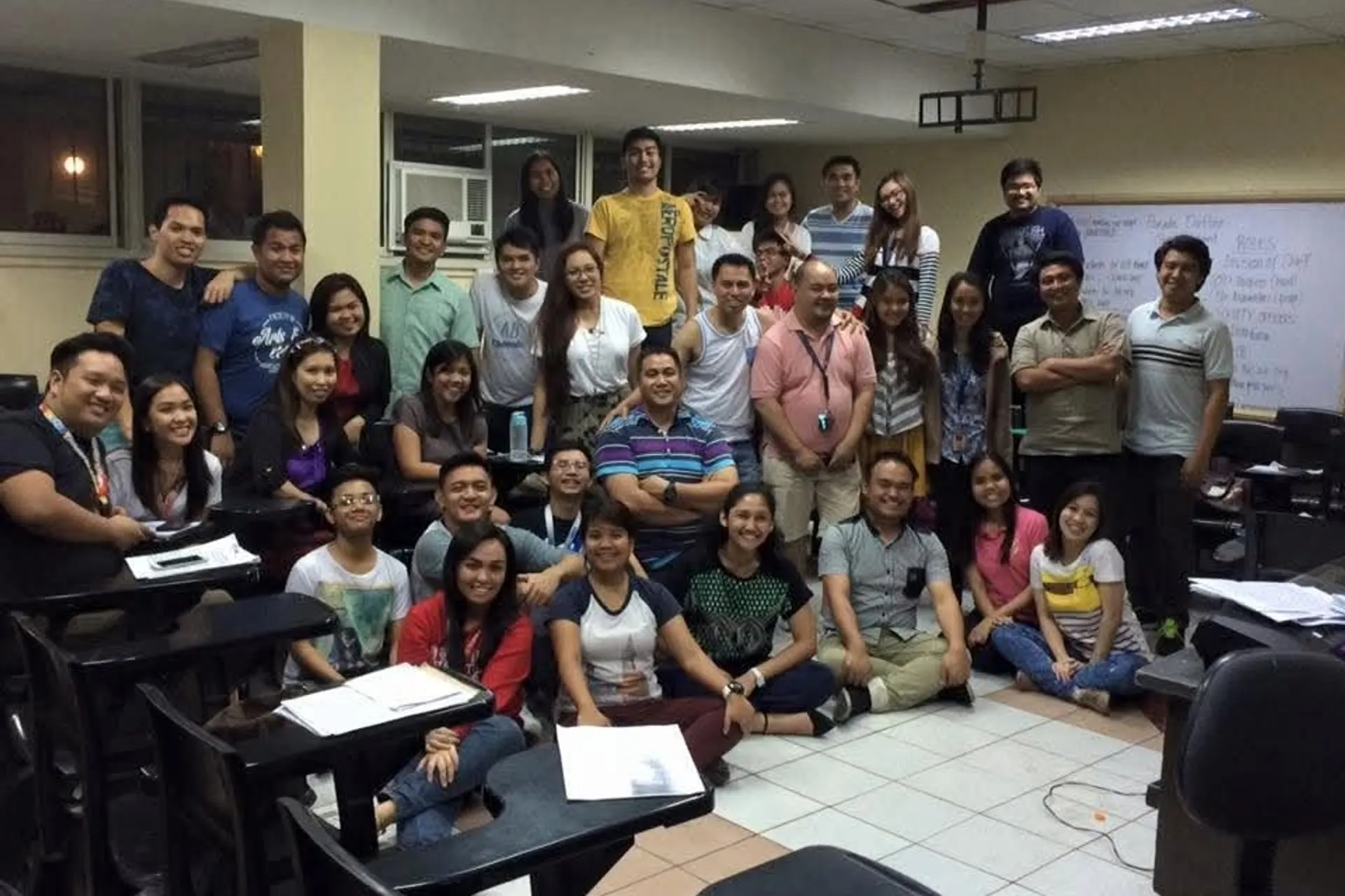 Alumni of different batches gathered in a classroom